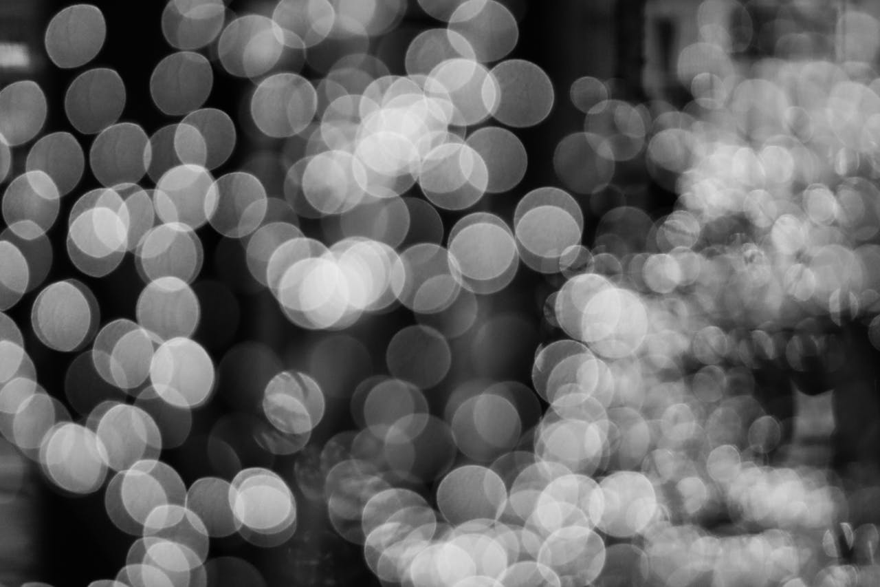 our-story Black and white bokeh lights creating an abstract and elegant background.